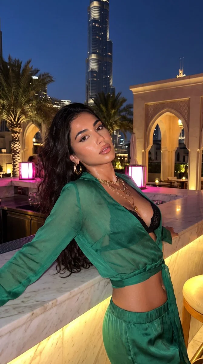 Emerald Silk and Gold Filigree Shimmer Against Dubai Skyline