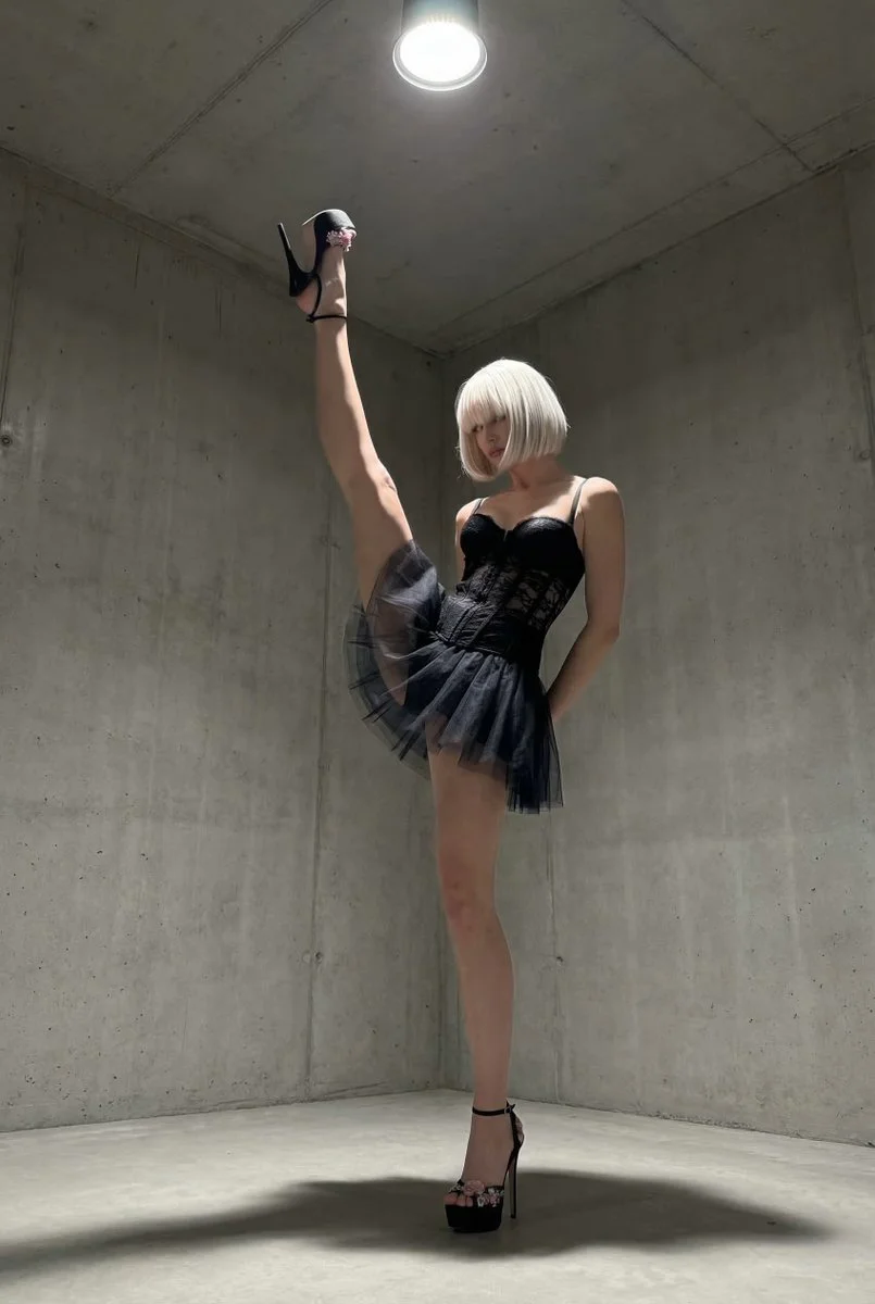 Fierce Elegance: Vertical Kick in Stark Industrial Light