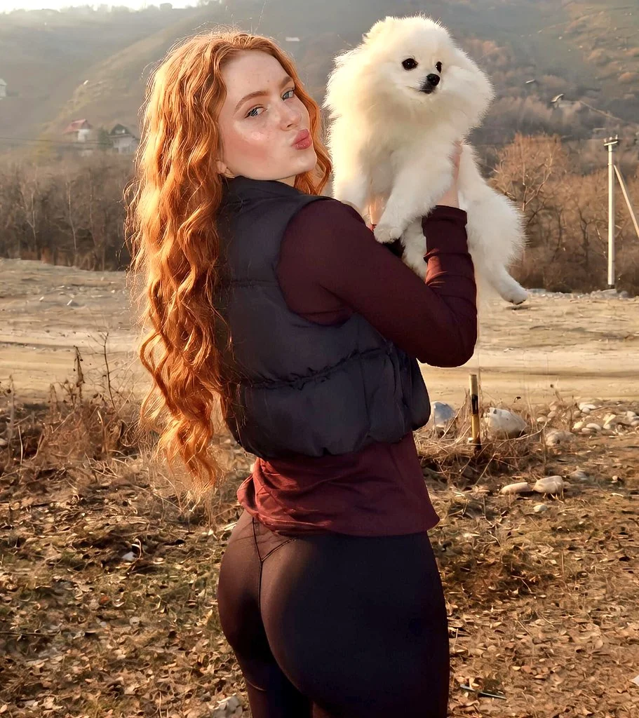 Ginger-Haired Woman Embracing Her Fluffy Pomeranian at Golden Hour