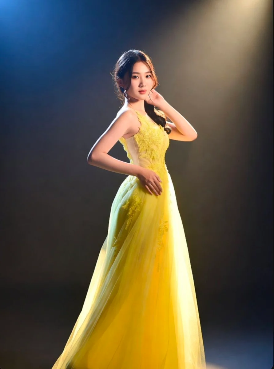 Glamorous evening wear shines through high-contrast studio lighting