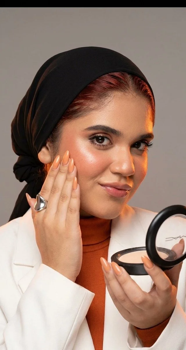 Glossy coral lips and glowing skin define this editorial portrait