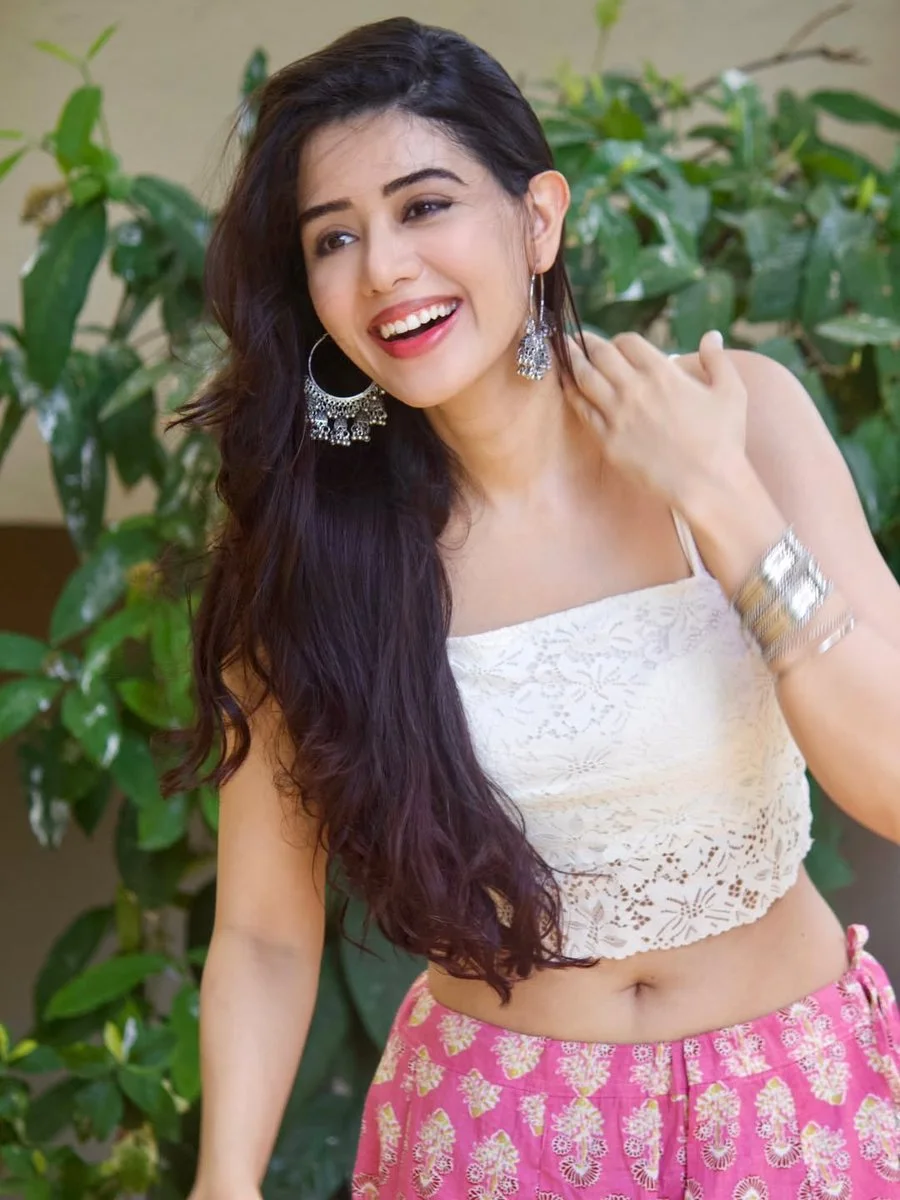 Golden hour portrait captures Indian woman's radiant smile and lace top