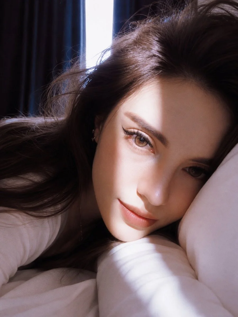 Golden hour portrait of a woman with aqua-green eyes in a car