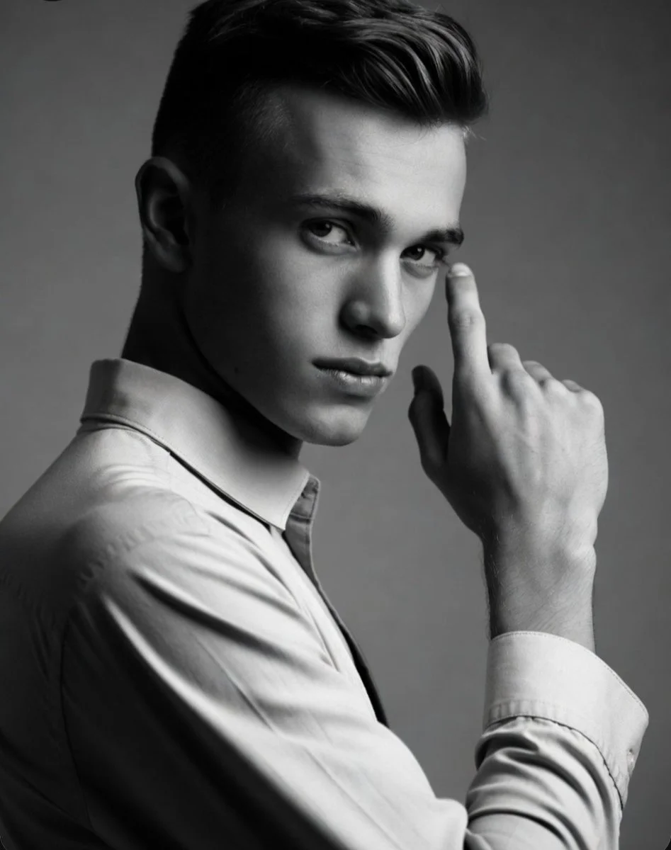 Handsome man with thoughtful gesture in moody studio shot