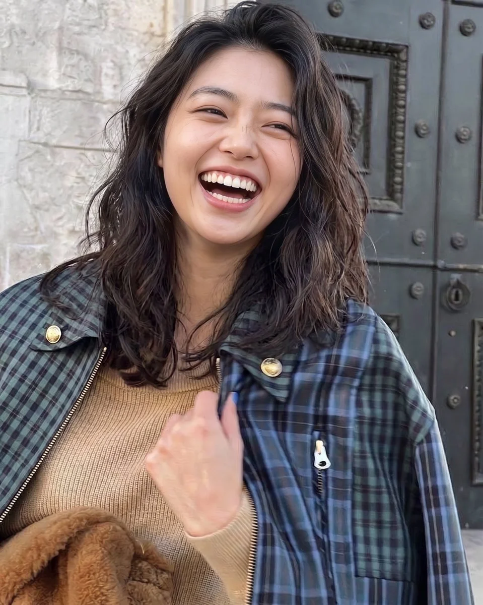 Joyful Woman Laughing in Autumn Stone Alley Wearing Tartan Jacket