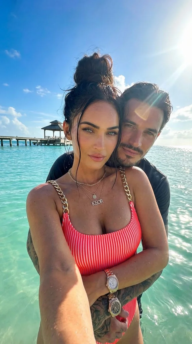 Megan Fox poses in neon swimsuit at tropical beach selfie