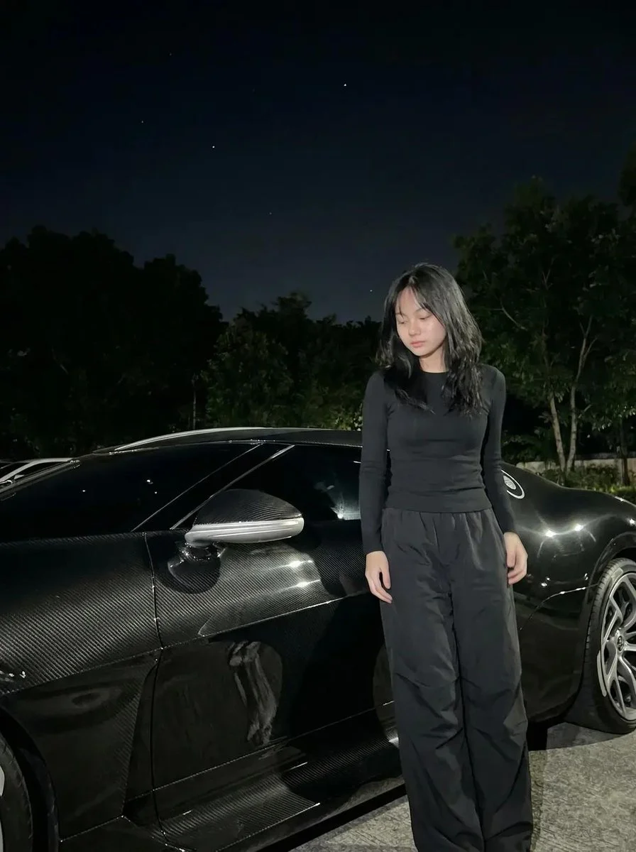 Midnight Elegance: Woman and Carbon-Fiber Sports Car Under Starry Sky