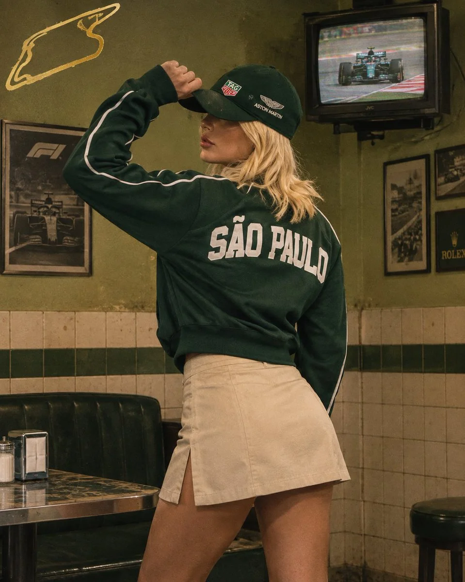 Model in Green Racing Jacket Poses in Retro Olive Room