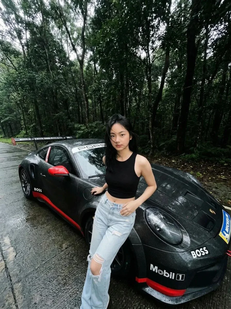 Moody Forest Drive: Young Woman by Wet Porsche 911