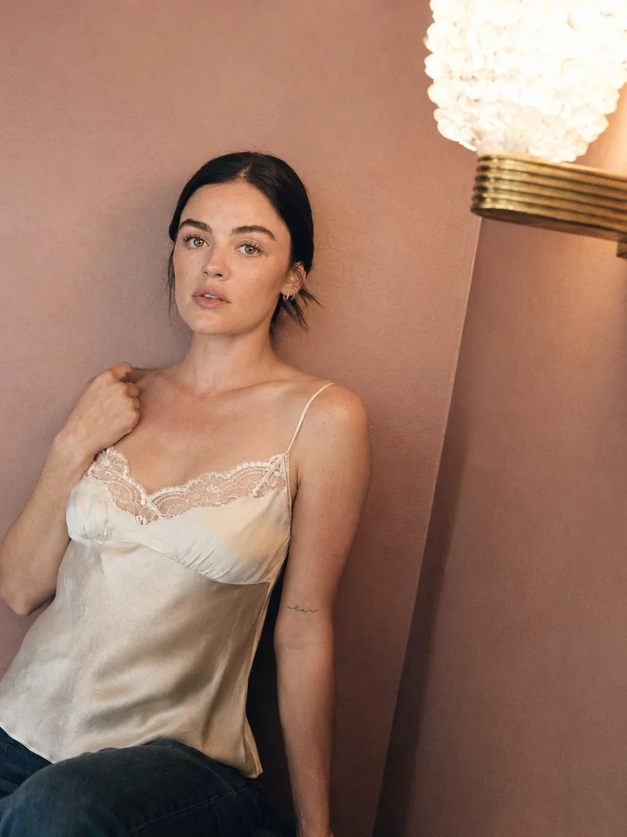Natural beauty with freckles poses thoughtfully in warm minimalist interior