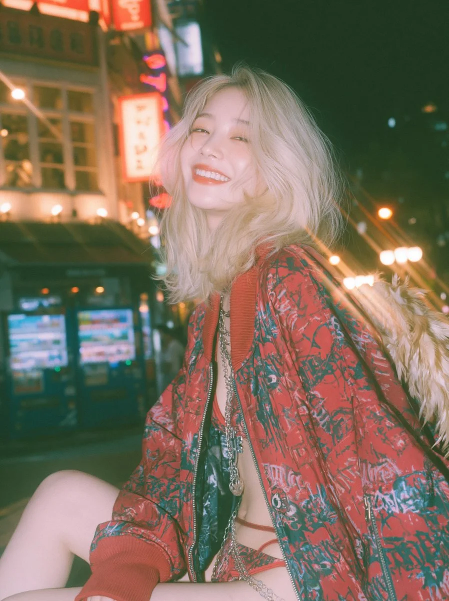 Neon-lit Soho portrait of a laughing woman with feather wings