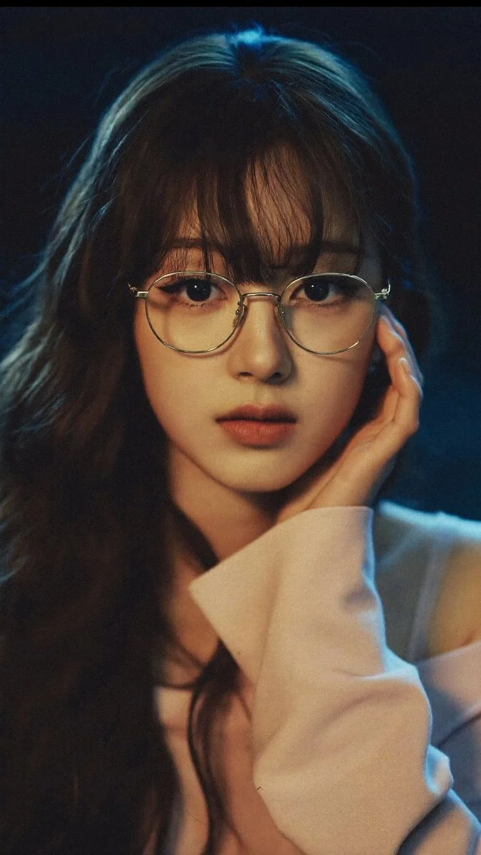 Night portrait of a woman in pink with glasses