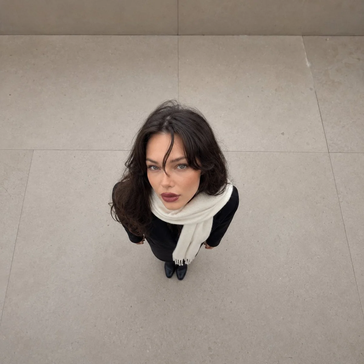 Overhead forced-perspective portrait shows giant head on tiny body