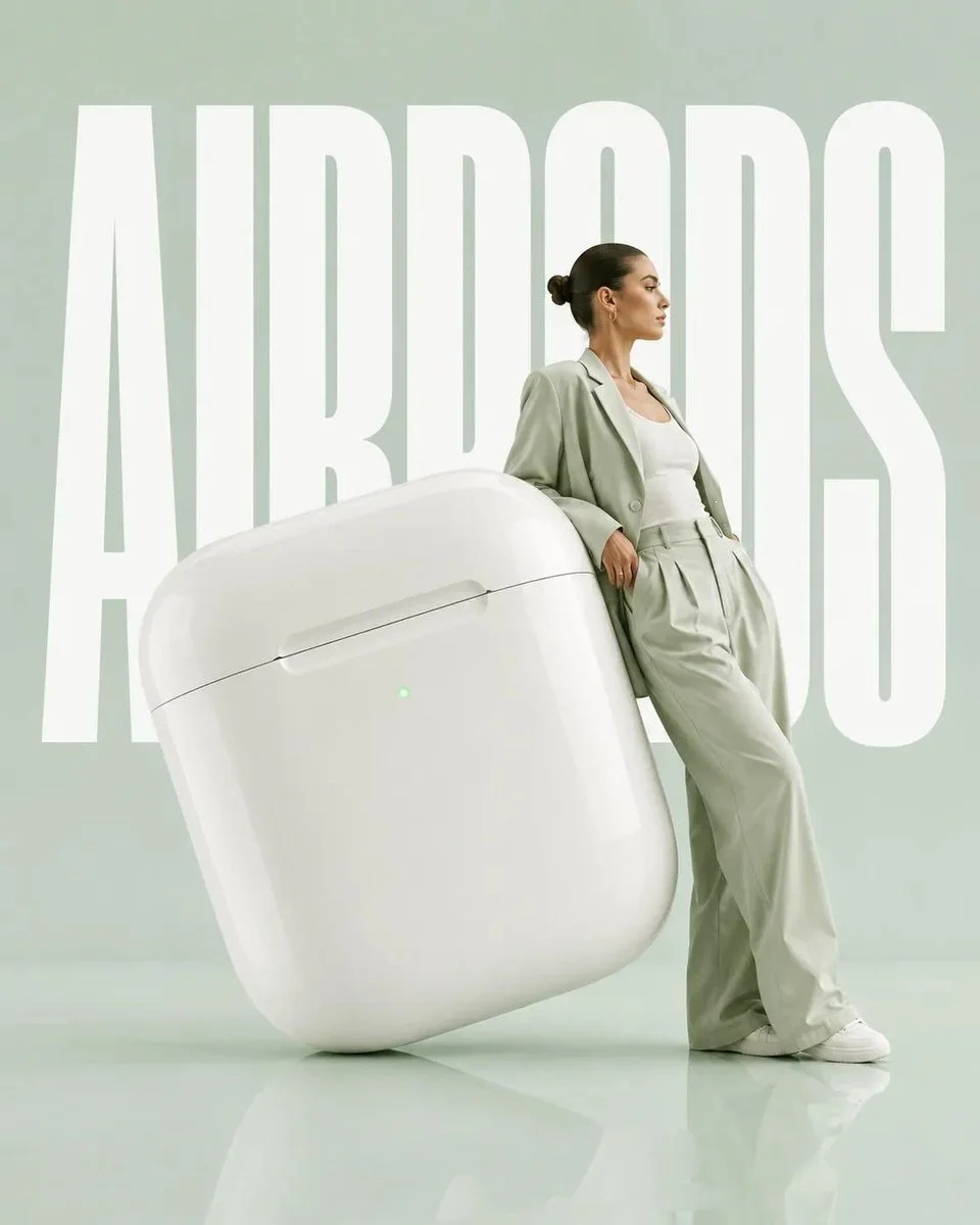 Oversized citrus sculpture supports a model in monochromatic editorial pose