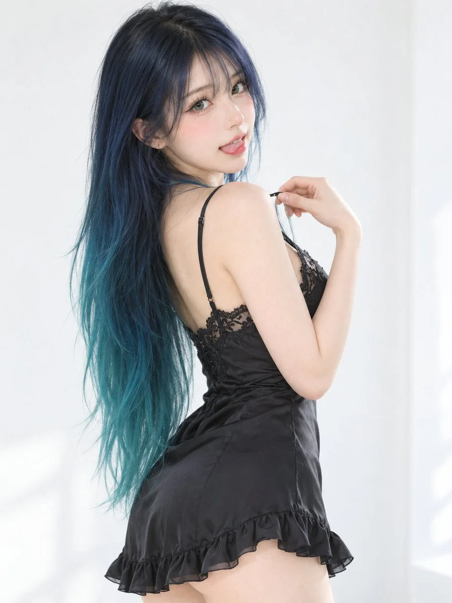 Playful East Asian model with teal-tipped hair poses in white studio