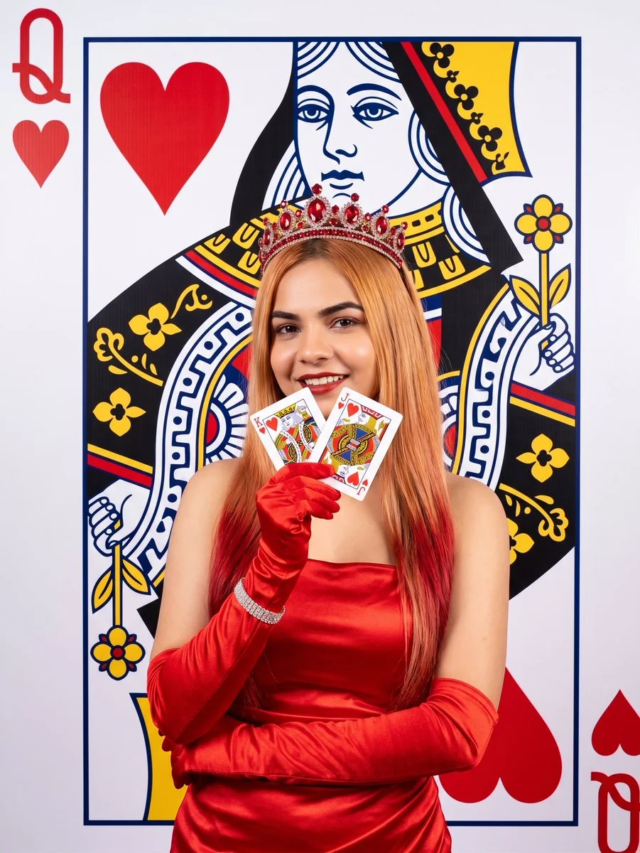 Playful Queen of Hearts Blends Into Giant Card Backdrop