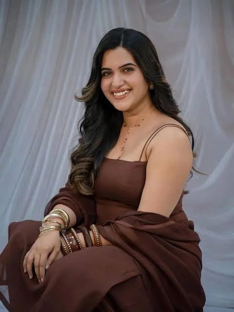 Radiant young woman gazes warmly under soft studio lighting