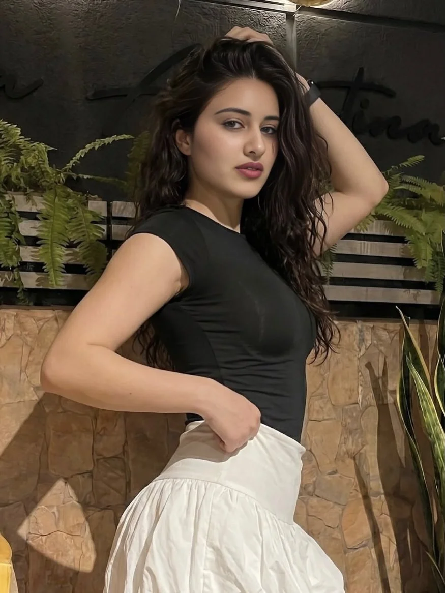 Seductive portrait of woman in black top and white skirt