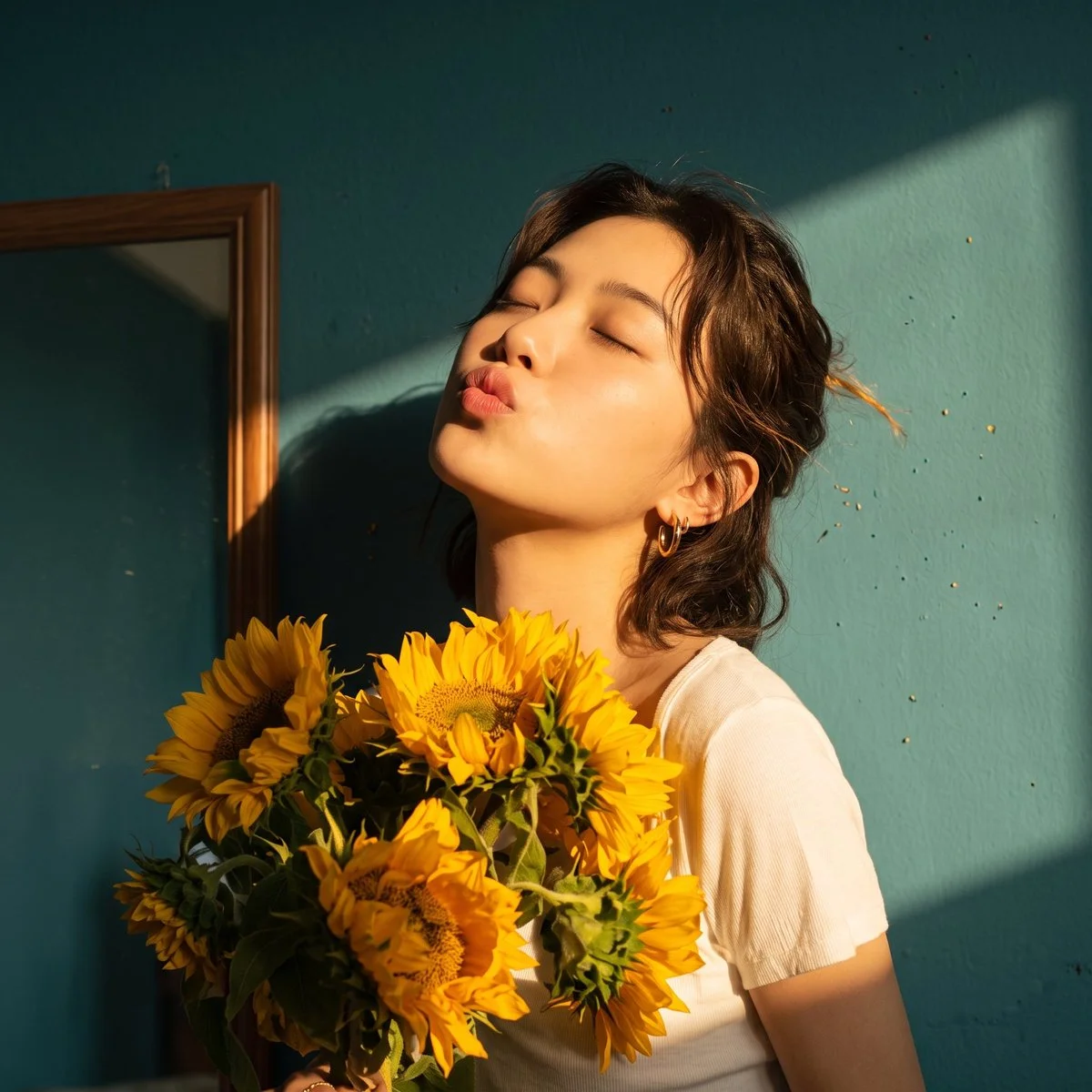 Serene Woman Embracing Sunflowers in Warm Sunlit Portrait