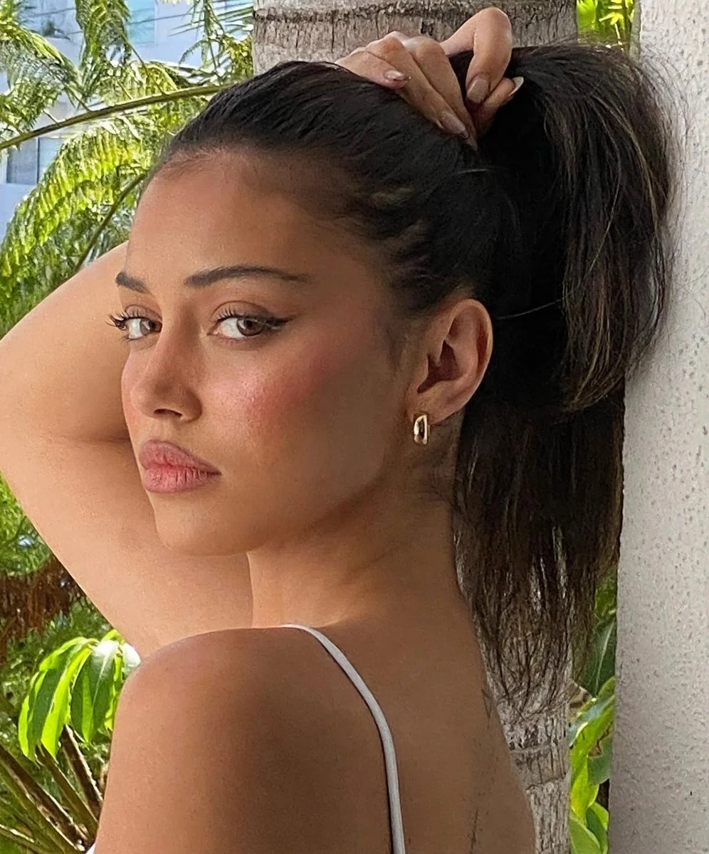 Side Profile Portrait of Woman with Sleek Ponytail in Tropical Light