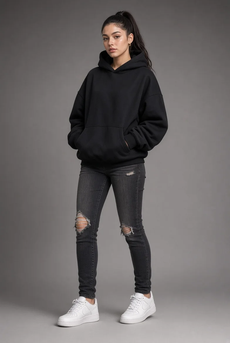 Sleek ponytail and heavy hoodie define minimal streetwear