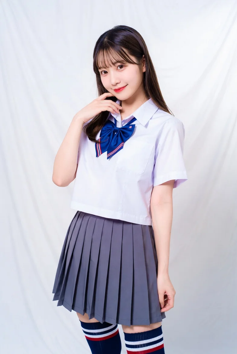 Soft studio light illuminates a schoolgirl's gentle smile and uniform.
