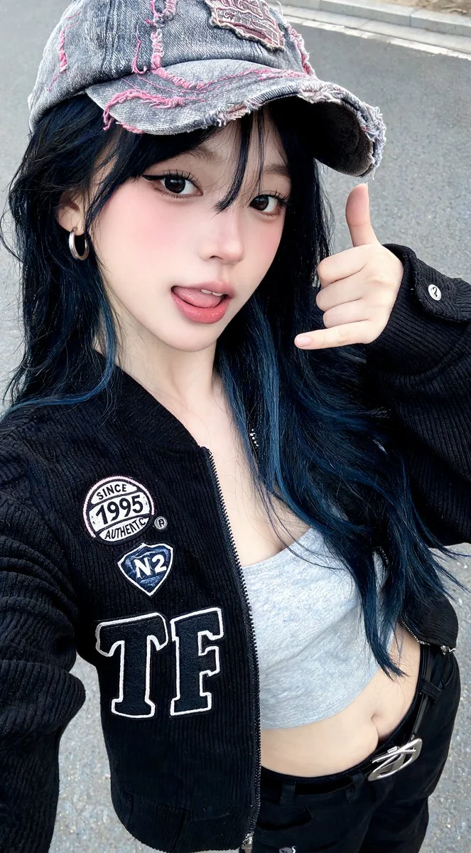 Streetwear-clad woman winks at camera with tongue out and shaka