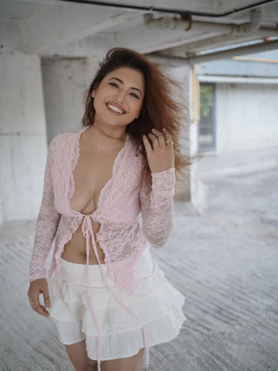 Sunlit portrait of a smiling woman in delicate lace