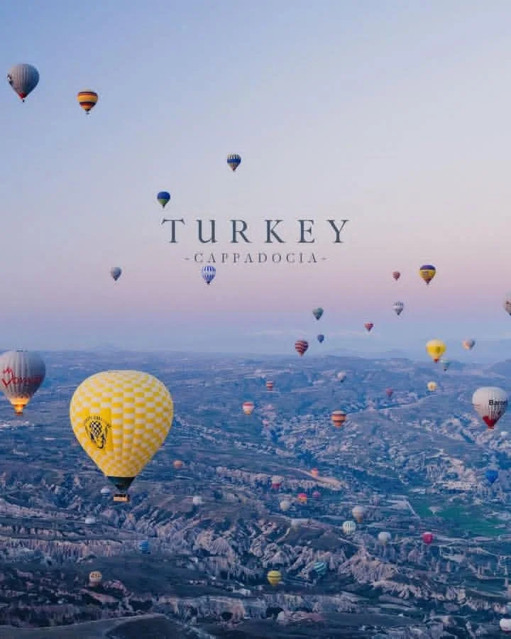Turkey's Cappadocia floats under a pastel sunrise sky