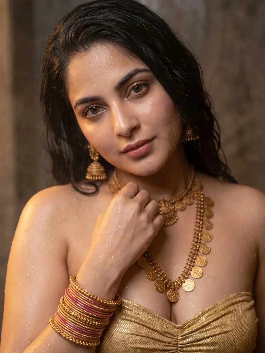 Water beads and gold adorn an Indian woman's radiant face
