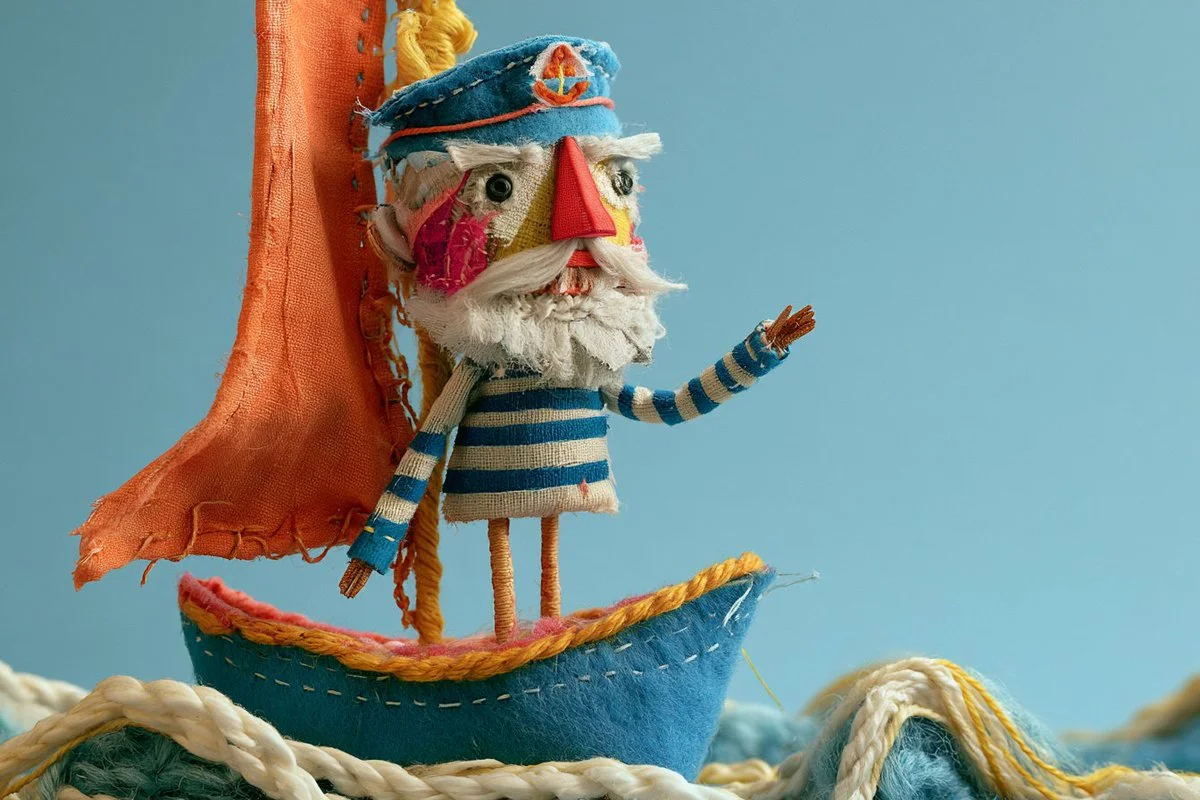 Whimsical Stitched Fabric Creature Poses on Handmade Textile Base