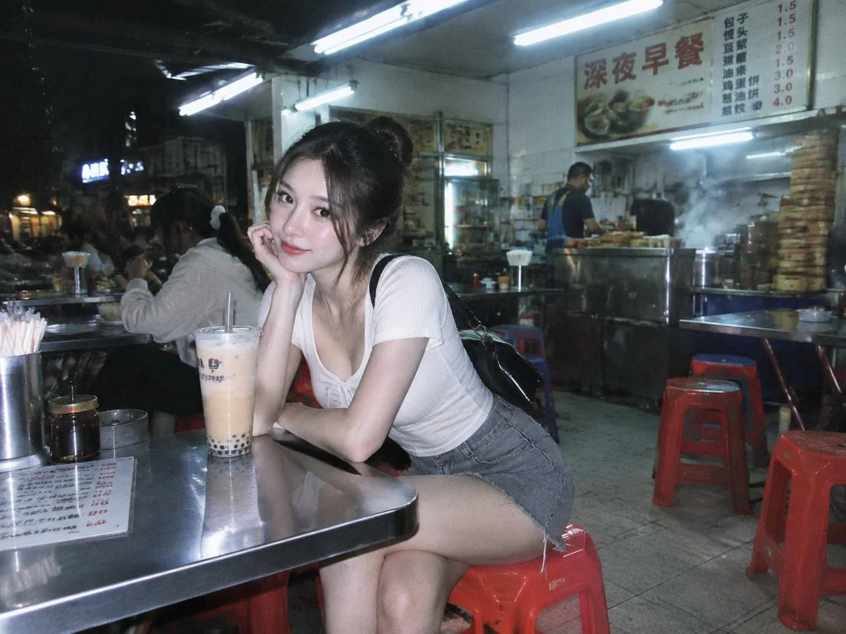 Woman sits on red stool in late-night Hong Kong diner