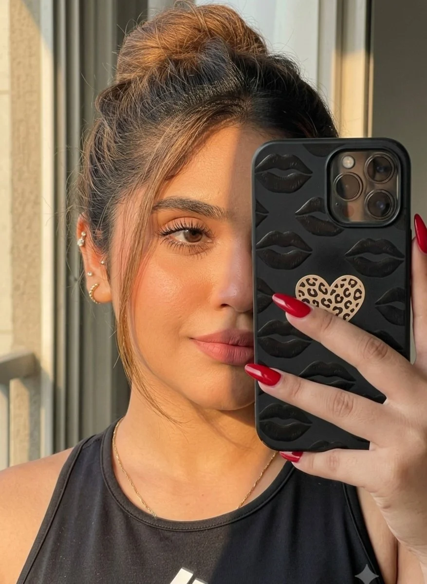 Young woman captures a golden hour mirror selfie with phone