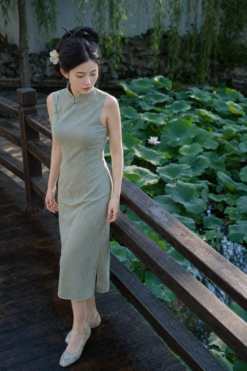Young woman pauses on a zigzag bridge over lotus pond