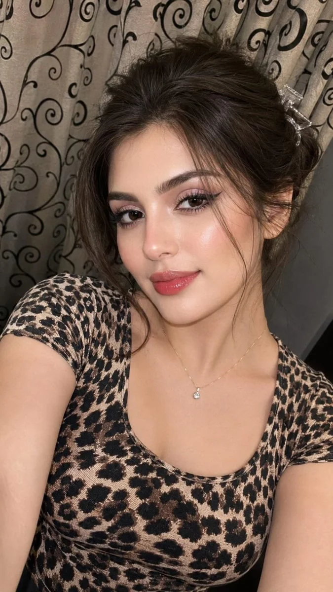Young woman takes a close-up selfie in leopard-print top